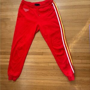 Wonder Woman DC red sweats with side stripes on one side.